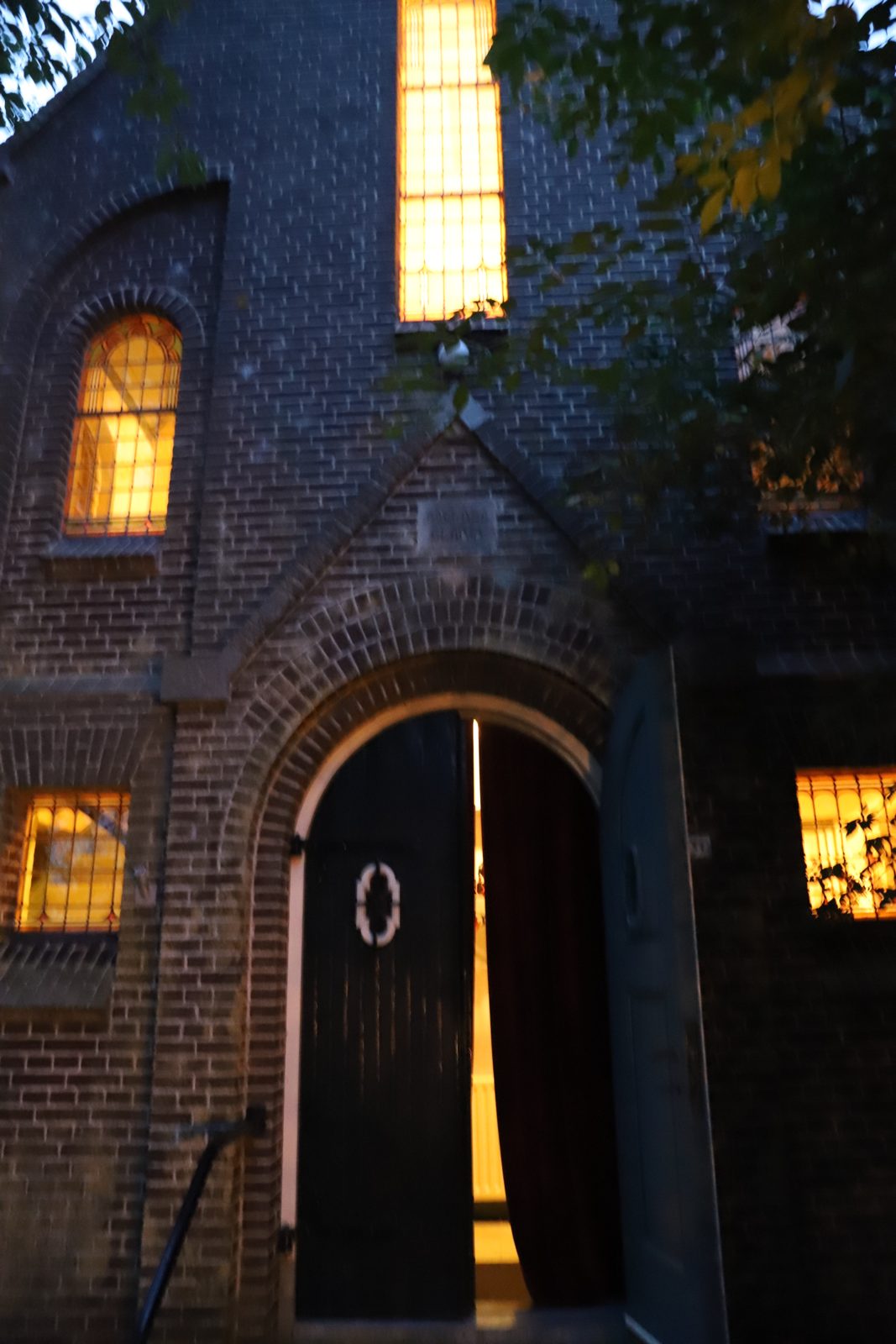 Verlichte ingang van 't Oude Kerkje in Garrelsweer